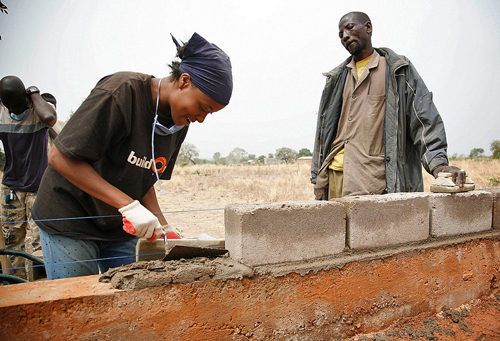 Woman lays bricks